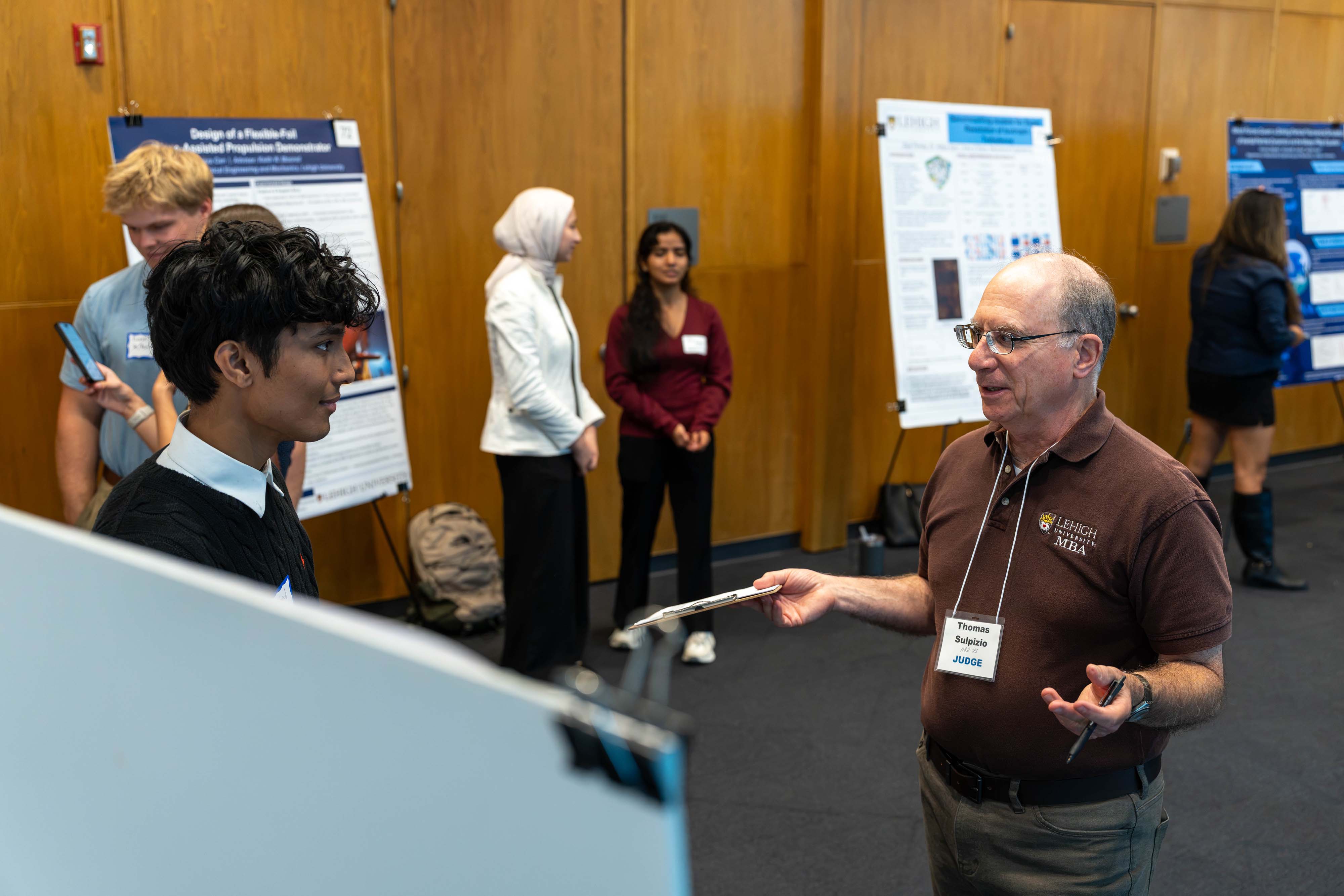 Sulpizio talks with a student to learn more about their project as part of the judging process.